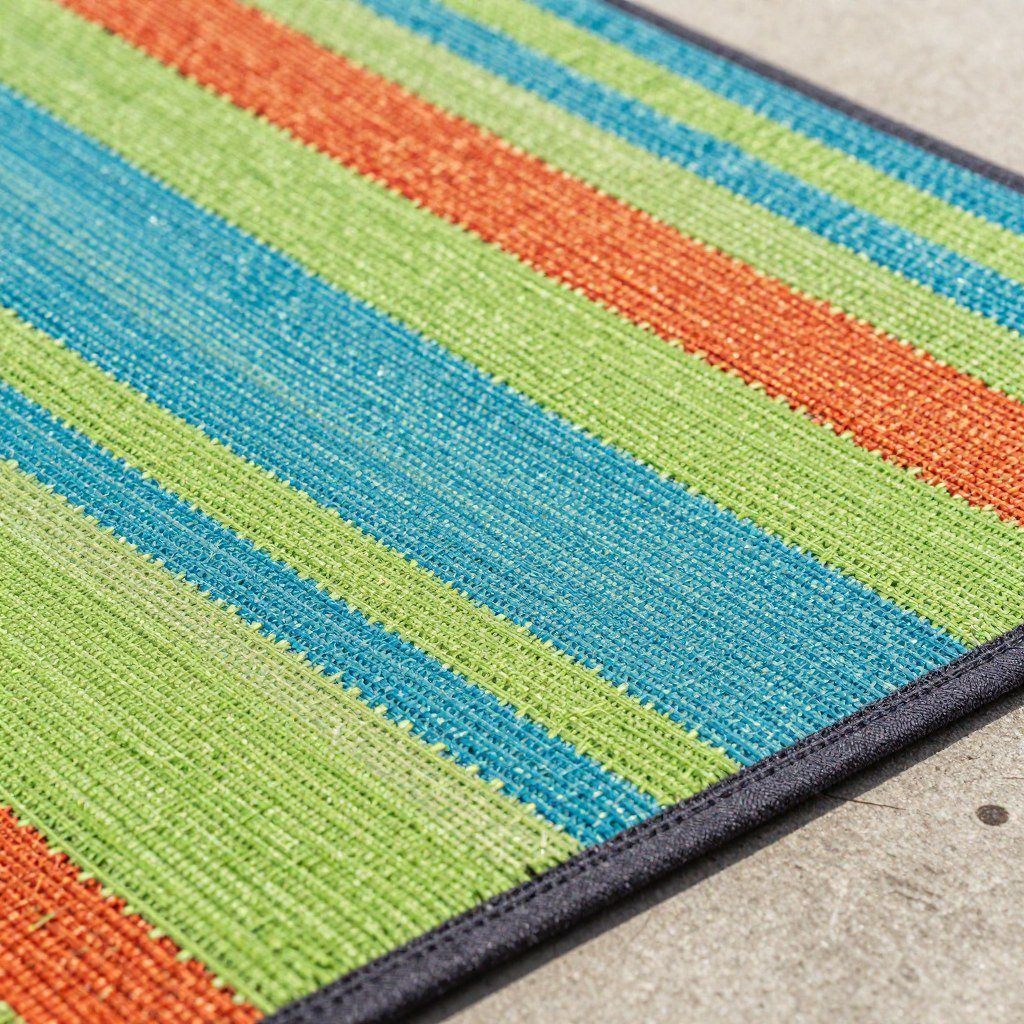 A colorful outdoor rug made from recycled plastic materials in a modern pattern