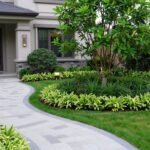 A well-balanced front yard landscape with layered plantings, a curved pathway, and focal point tree