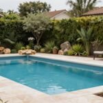 A well-designed pool area with careful landscaping showing plants and hardscaping elements arranged around a swimming pool