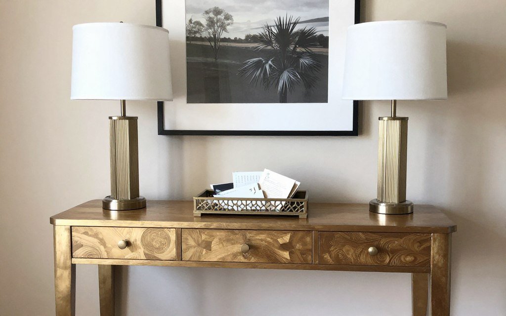 An Art Deco vanity cleverly repurposed as a stylish entryway console with contemporary accessories