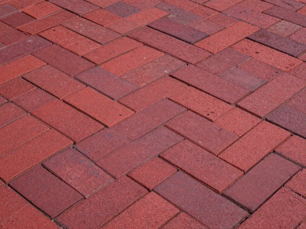 Brick paver patio in herringbone pattern with rich red tones Brick paver patio in herringbone pattern with rich red tones