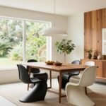 Bright mid century modern dining room with walnut table, iconic chairs, and pendant lighting