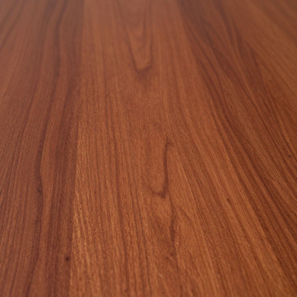 Close-up of a cherry dining room table surface showing its warm reddish-brown color