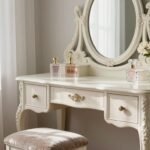 Elegant vintage vanity setup with ornate mirror, plush stool, and decorative accessories creating a vintage vanity aesthetic