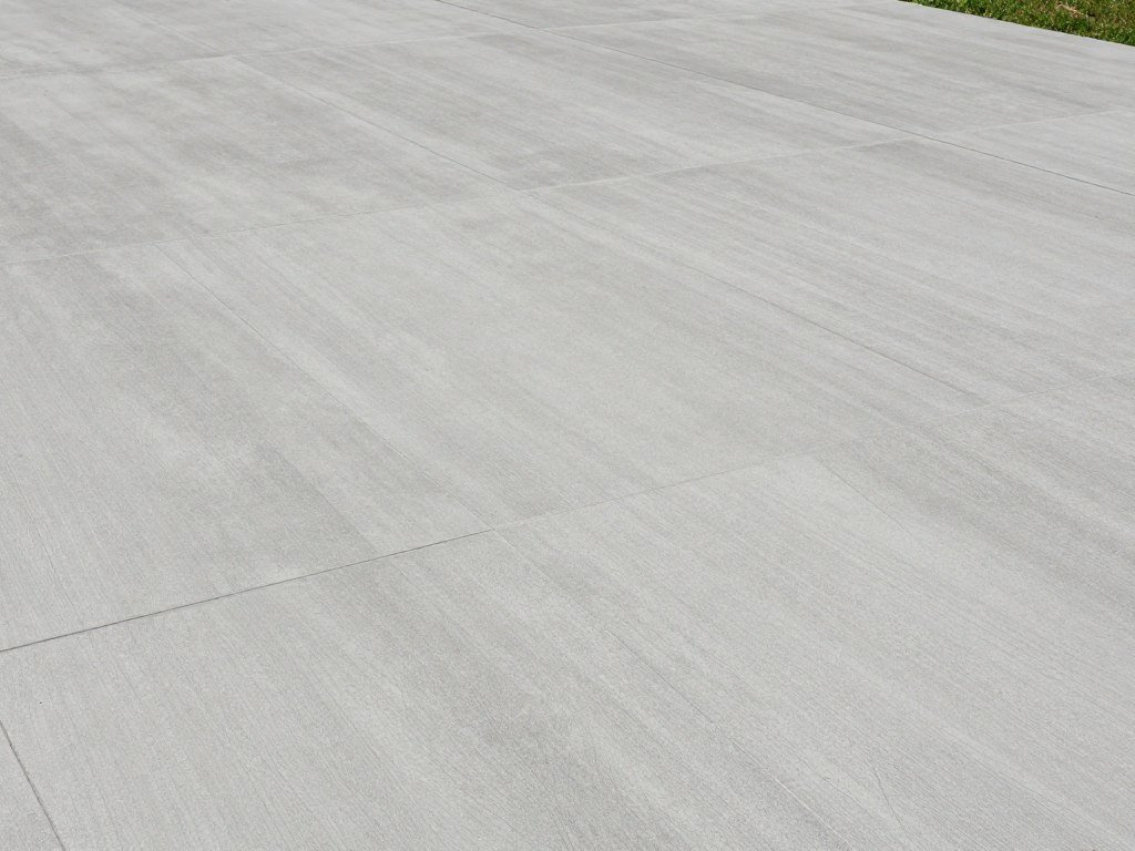 Modern concrete patio with stamped pattern resembling large format tiles Modern concrete patio with stamped pattern resembling large format tiles