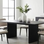 Modern dining room with black dining table and contrasting white decor elements