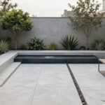 Modern minimalist backyard with clean lines, concrete pavers, and strategic plantings