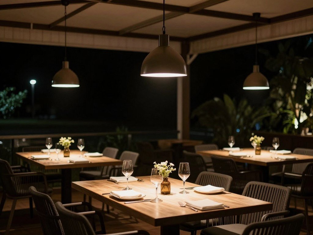 Outdoor dining area with pendant lights hanging over the table creating an intimate atmosphere