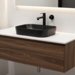 Sleek floating bathroom vanity with matte black hardware and vessel sink against a white tiled wall
