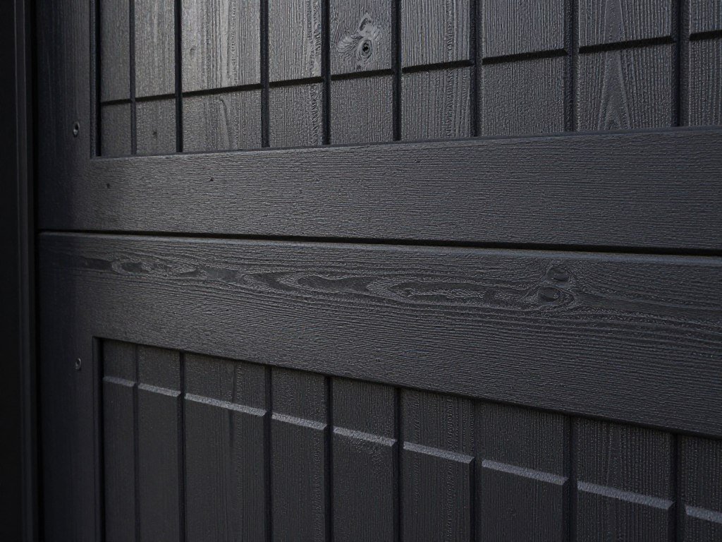 Black wood garage door showing natural grain and texture