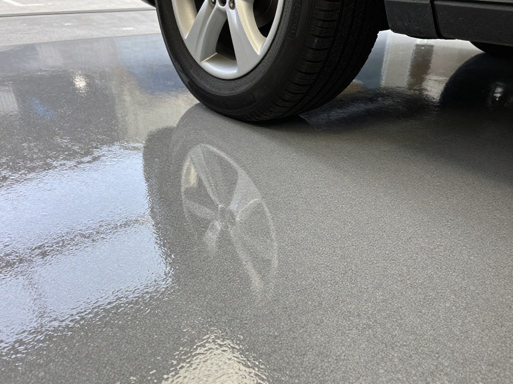 Close-up of glossy epoxy garage floor showing durability and stain resistance Close-up of glossy epoxy garage floor showing durability and stain resistance