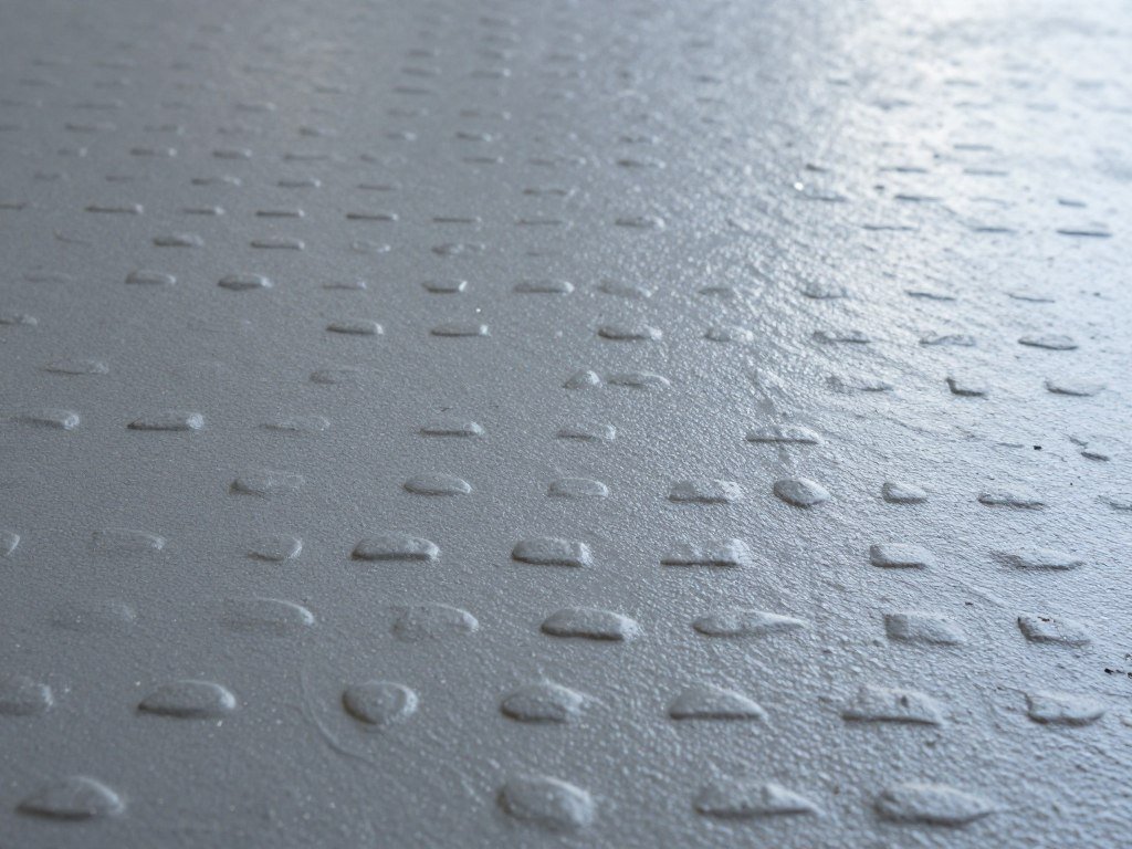 Close-up of painted garage floor with anti-slip texture showing improved grip