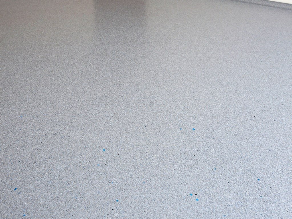 Epoxy garage floor with multicolored flakes in gray, blue and black