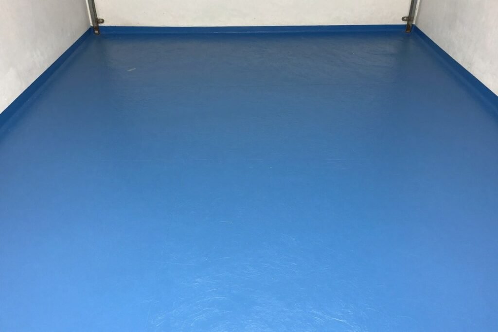 Garage with painted concrete floor in solid blue color