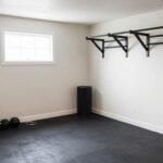 Small garage transformed into a compact home gym with wall-mounted equipment