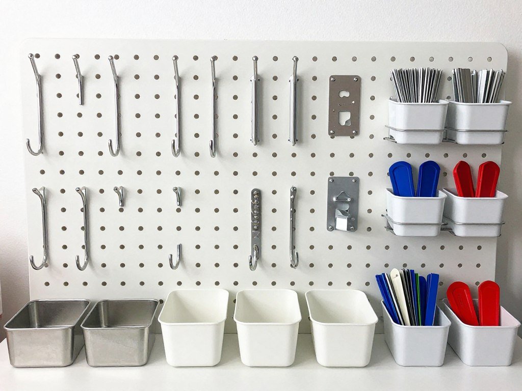 Various pegboard accessories including hooks, bins and tool holders