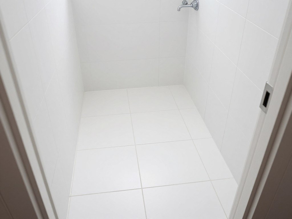 Diagonal tile pattern expanding narrow bathroom