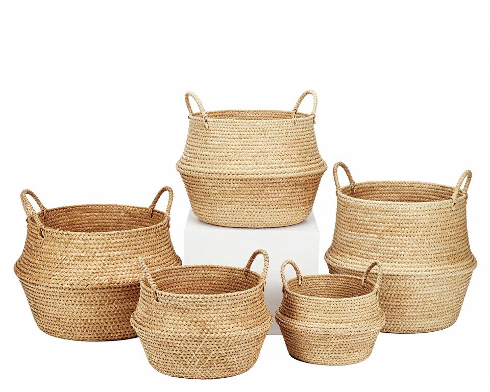 Set of woven storage baskets in natural materials with handles