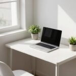 modern minimalist desk setup in small apartment corner with natural light